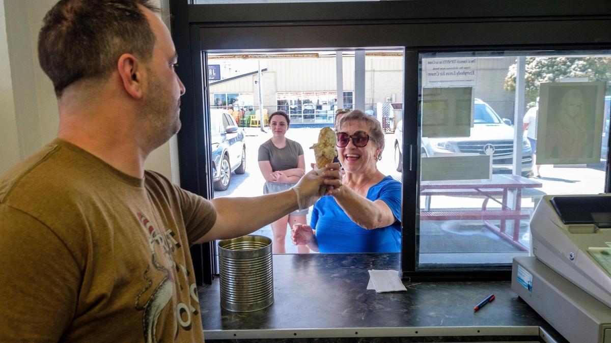 Dominic Monaco serves scoops of ice cream at The Original Painter’s Ice Cream in North Myrtle Beach which opened in 1952. April 22, 2022.