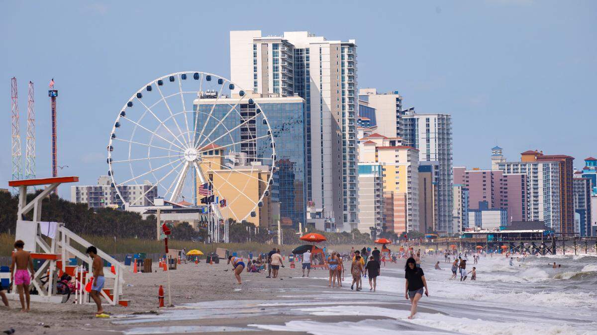 Visitors head to the neach in downtown Myrtle Beach in July. July 1, 2024.