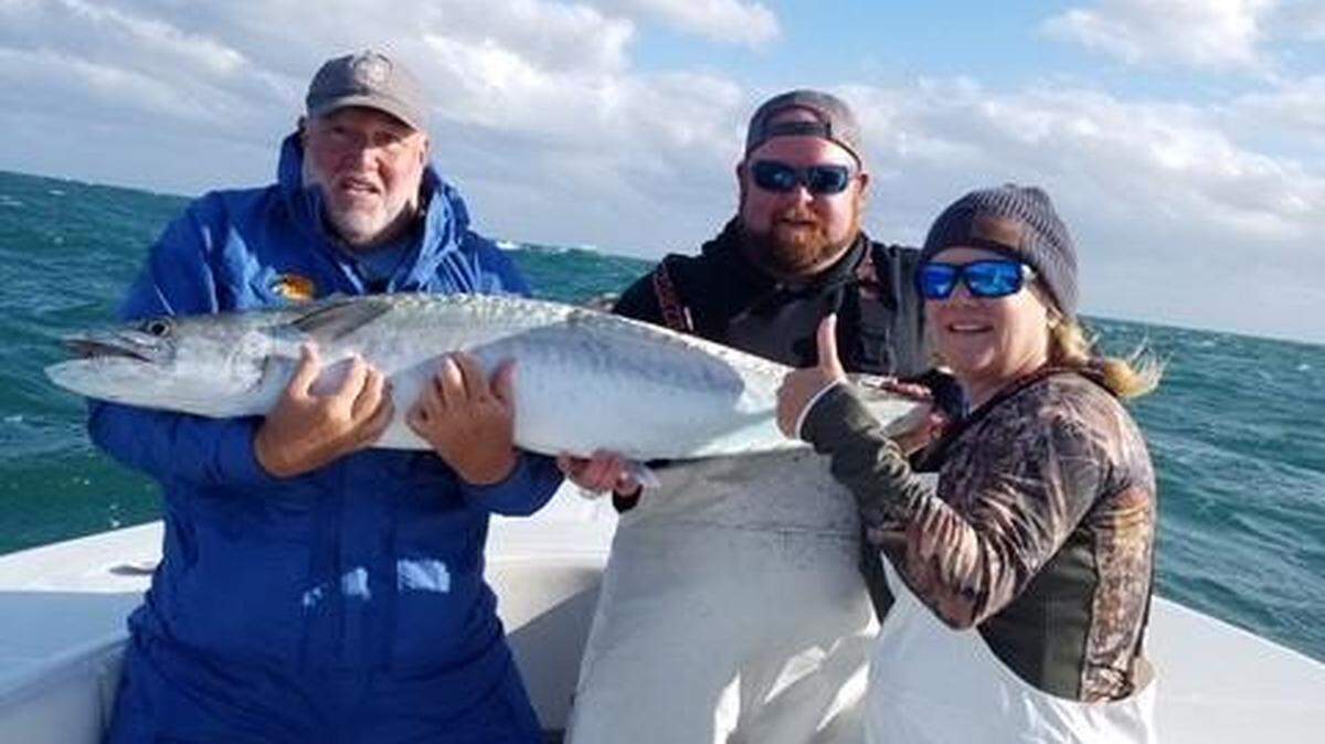 Jody Gay, Kevin Sneed and Kimber Sneed show off their 48-pound king mackerel during The Kingfish Cup Sunday off Ocracoke, N.C.