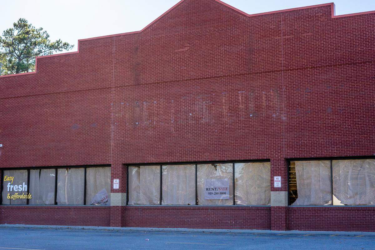 The closed Food Lion grocery store sits empty with “for rent” signs in the windows. Myrtle Beach residents, advocates and experts say the Food Lion closing will worsen the struggles of a mostly Black and Latino community where over a third of residents live below the federal poverty line.