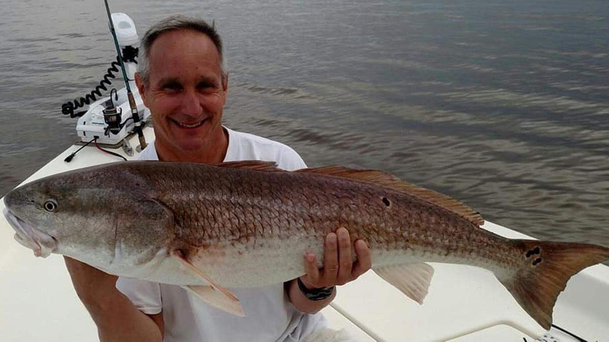 Will Duke of Marietta, Ga., shows off a bull red drum he caught and released Tuesday while fishing in Winyah Bay with Capt. Mike McDonald of Gul-R-Boy Guide Service.