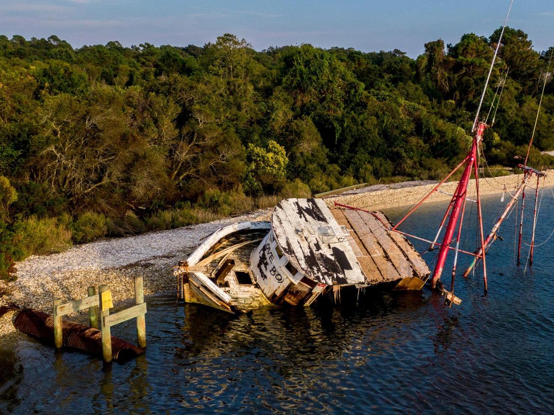 An abandoned shrimp boat called ‘Sum Day’ that was wrecked on the shoreline of the Intracoastal Waterway between Little River and Calabash known as the “Crossroads”, was removed in a joint effort by the South Carolina Natural Resources, the conservation group Wounded Natural Working Veterans, and local volunteers from Black Water Dredging. Abandoned boats litter the waterways throughout Horry County, S.C. The Department of Natural Resources is partnering non-profit conservation groups and local businesses to begin removing the derelict vessels from local waterways. Oct. 14, 2021.