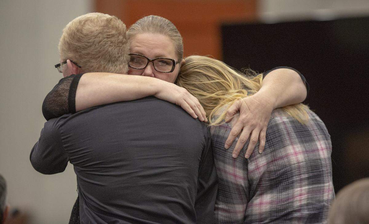 Tammy Moorer hugs her children after she was found guilty of conspiracy and kidnapping Heather Elvis on Dec. 18, 2013.