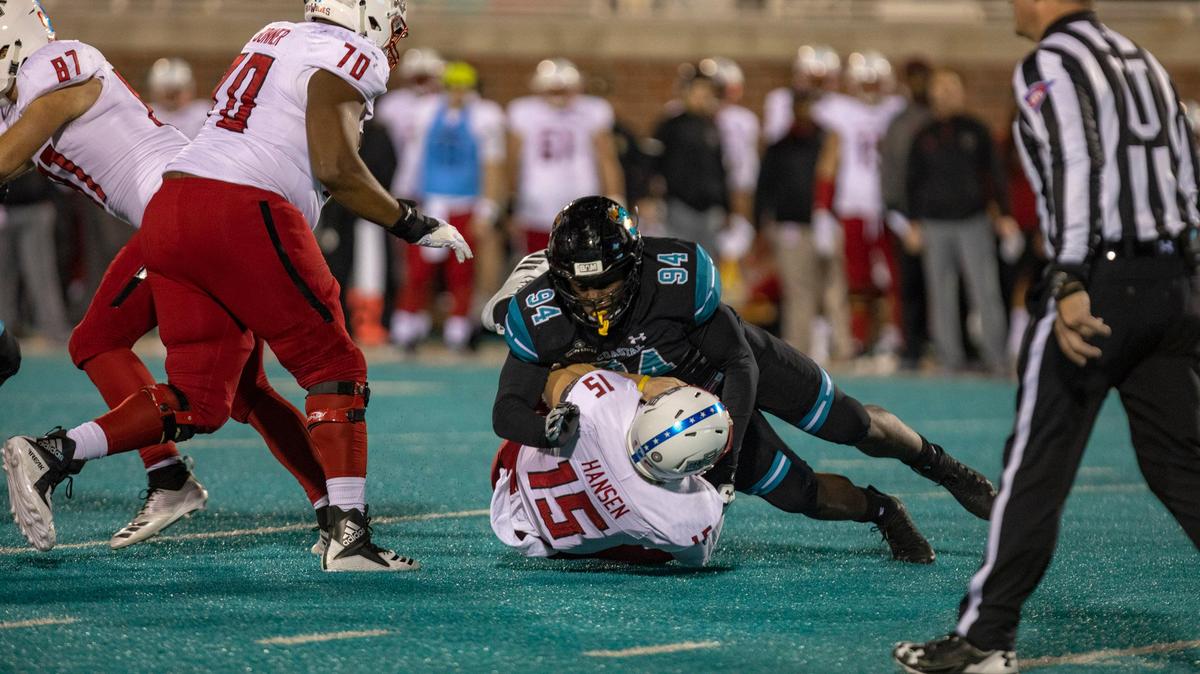 Coastal Carolina sophomore defensive end Jeffrey Gunter sacks Arkansas State senior quarterback Justice Hansen on Nov. 10, 2018 at Brooks Stadium in Conway.