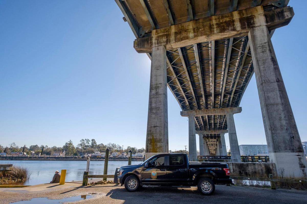 A member of the South Carolina Department of Natural Resources waits alongside family and friends of Tyler Doyle at the T.Craig Campbell Boating Facility in Little River S.C. This is the eleventh day of searching for the duck hunter after his boat took on water while hunting near the Little River jetties. February 6, 2023.