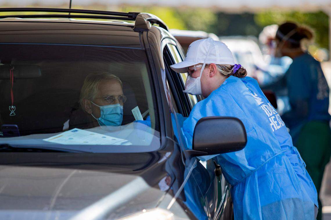 Tidelands Health medical professionals conduct a drive-through COVID-19 testing site in July at Myrtle Beach Pelicans Ballpark.