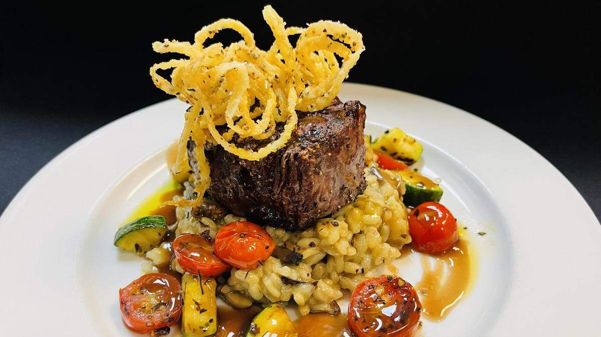 A cut of steak on a bed of risotto from CK’s Bistro, which opened in The Market Common in 2024. CK’s Bistro