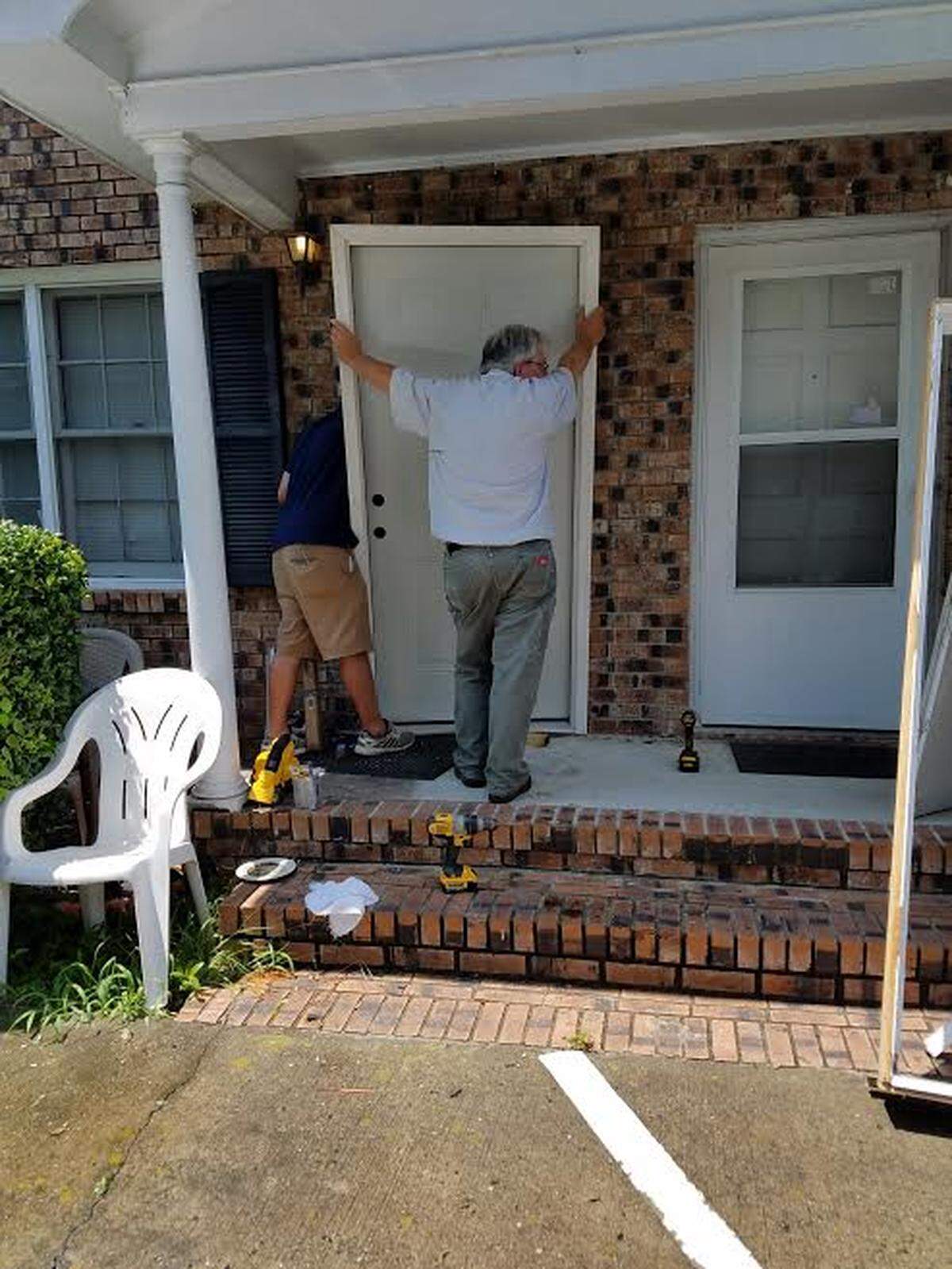 Myrtle Beach city employees fix a door at the Magallanes house after a police raid on July 25, 2018.