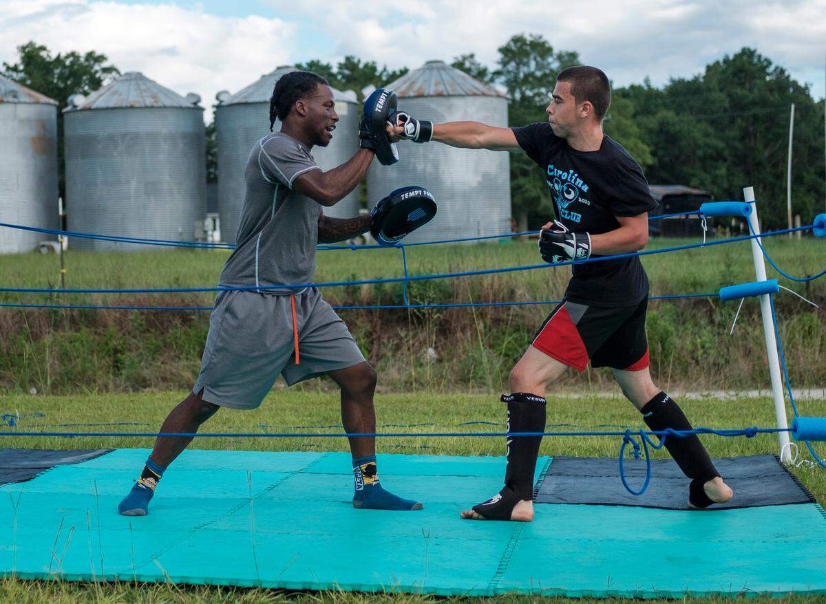 Nate Jenkins spars with Jeramiah “Jumbo” Ledesma in an Aynor back yard prior to boxing matches in 2020.