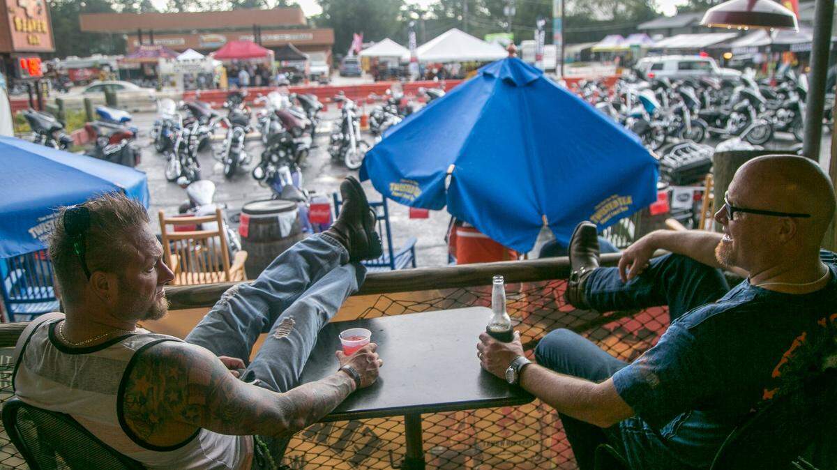 Bikers sit under the covered porch of The Beaver Bar in Murrells Inlet, SC as rain falls. TSN FILE
