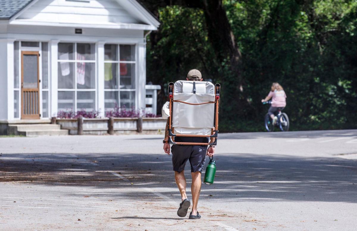 A camper walks to the beach at Myrtle Beach State Park. Sept. 4, 2024.