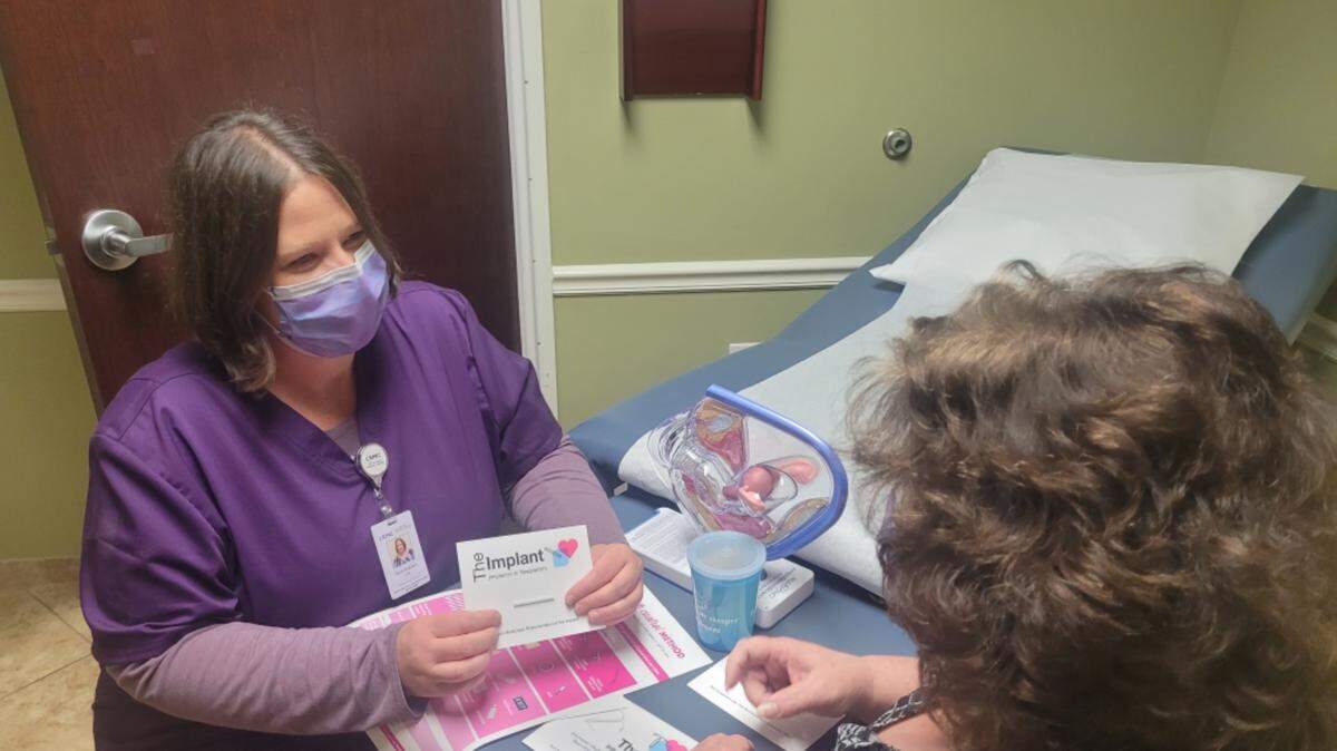 A Little River Medical Center nurse reviews birth control products with a patient