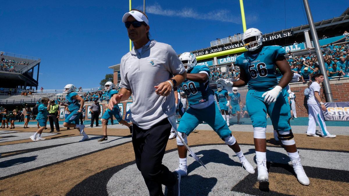 Coastal Carolina football coach Jamey Chadwell leads his team on the field against Massachusetts at Brooks Stadium in Conway SC on Aug. 11, 2021.