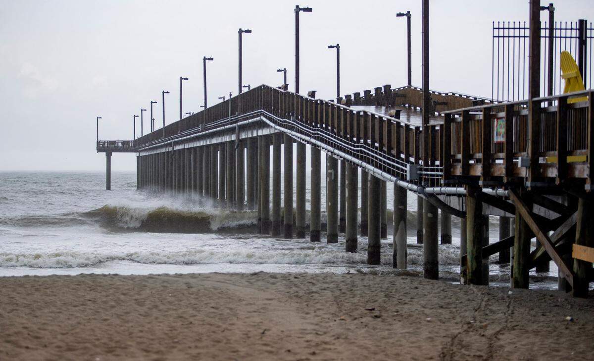 Waves crash into Springmaid Pier Saturday afternoon in Myrtle Beach as Hurricane Isaias approaches the eastern seaboard.