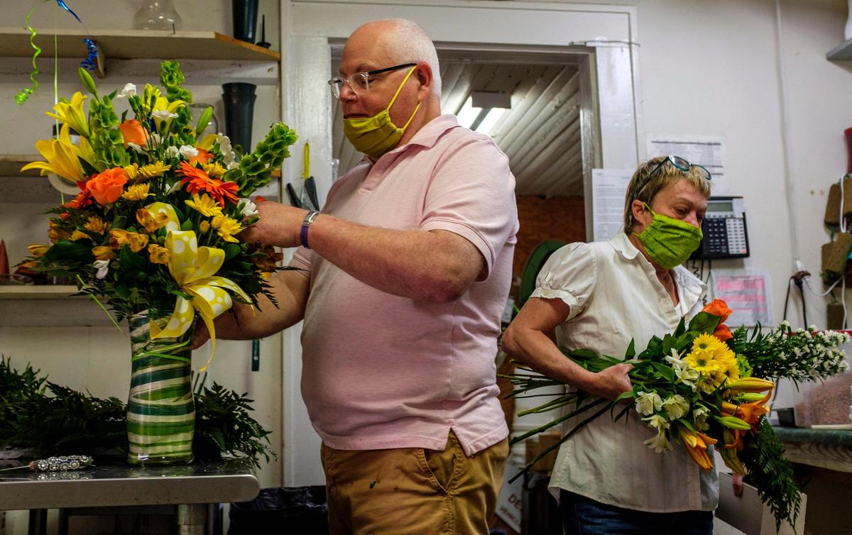 Daved Kindard,owner of Daisy Fair Flowers, and Jodie Wilson prepare fresh flower arrangements after re-opening their shop in Conway, S.C. With Mother’s Day in just two weeks, florists are in a difficult position determining whether to open or remain closed during the coronavirus. April 23, 2020