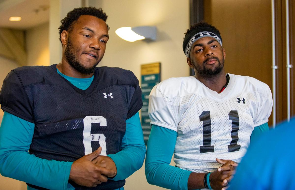 Coastal Carolina senior defensive tackle Sterling Johnson (6) and senior tight end Shadell Bell (11) speak with The Sun News before practice Tuesday afternoon at Brooks Stadium in Conway.