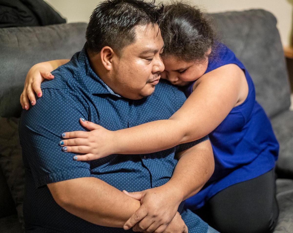 Faith Ruiz, 8, hugs her father Javier Ruiz after he gets emotional talking about his child’s condition. Faith has Bardet-Biedl Syndromee, a rare genetic disorder linked to childhood obesity and vision problems with most of those afflicted going legally blind by age 15. The Ruiz family hopes to travel to Marshfield, Wisconsin to get testing with the nation’s only specialty clinic for BBS but the Ruiz family must first overcome financial burdens before Faith can get the help she needs. January 28, 2021.