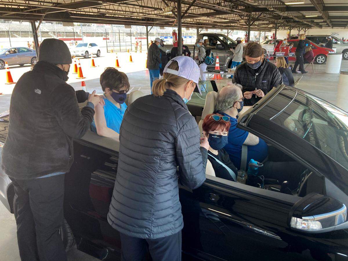 Three people get receive their second Moderna vaccine doses at McLeod Health’s mass clinic at Darlington Raceway on April 1, 2021.