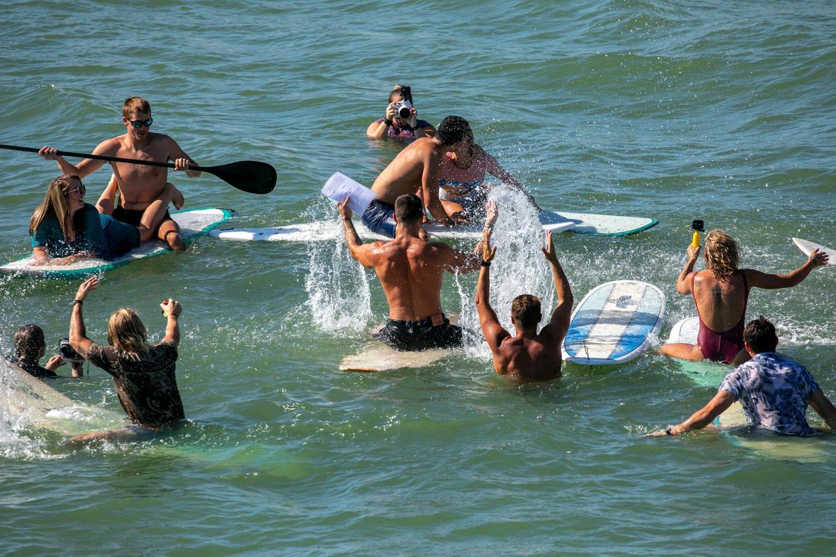 Ashley Yarborough and Dylan McCann got married on their surfboards near the Cherry Grove Pier in North Myrtle Beach on Saturday as family, friends and fishermen watched from the pier. The couple are former North Myrtle Beach lifeguards and avid surfers. They were surrounded in the surf by about two dozen fellow surfers and Ashley’s 5-year-old daughter Jordyn. Oct. 12, 2019.