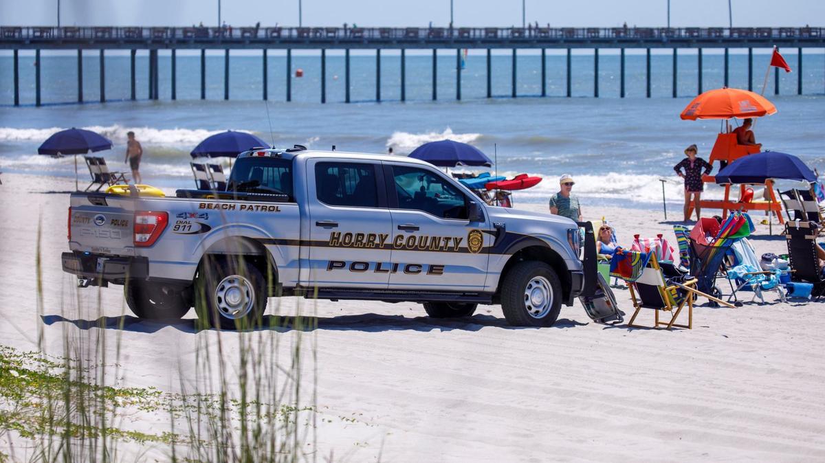 Horry County Police block off a section of the beach as South Carolina State Troopers investigated the the scene of an incident that happened Thursday near the Nash Street beach access. A female sunbather was killed after being struck by an Horry County Police vehicle. June 14, 2024.
