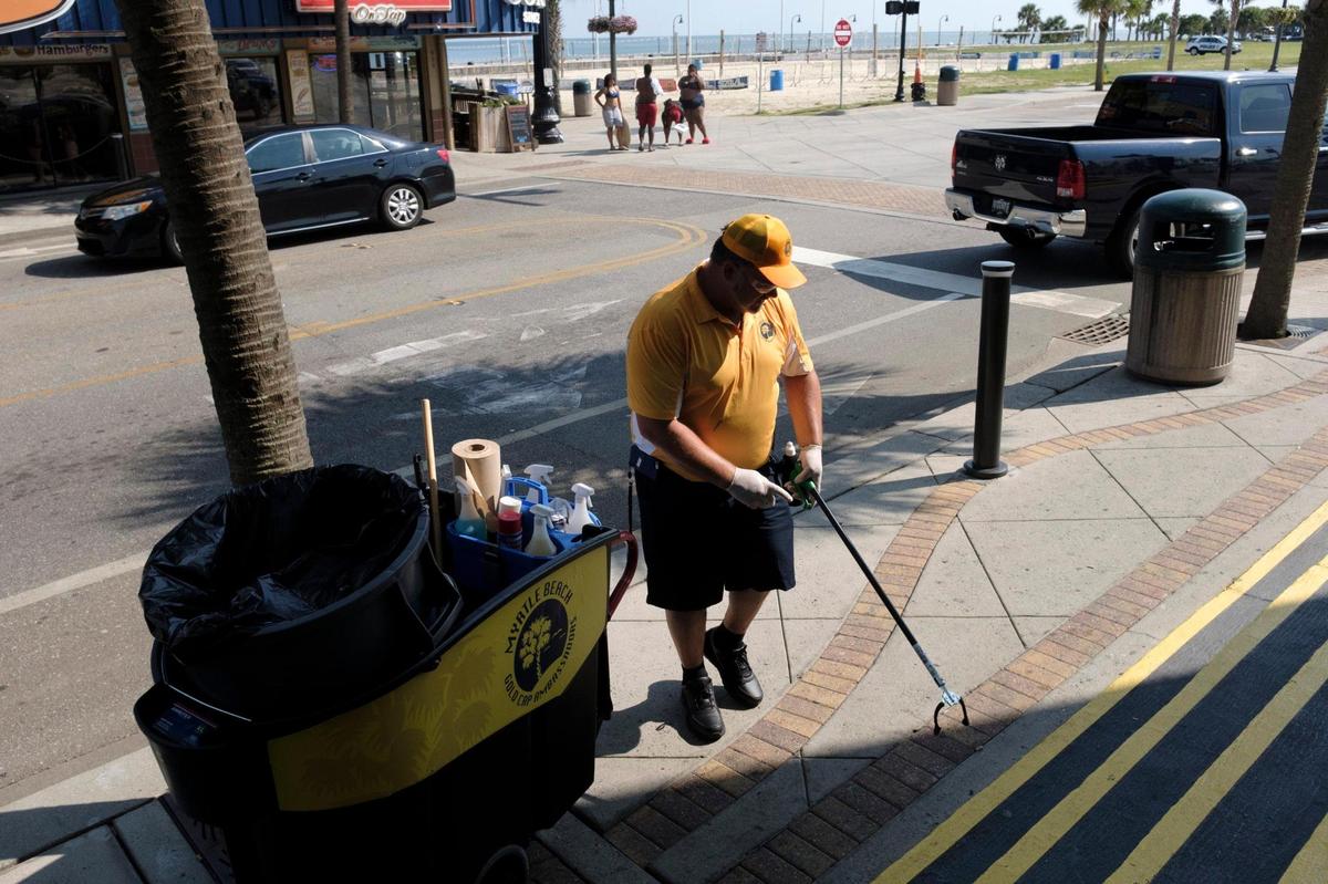 Jeremy Trendle picks up cigarette butts along Myrtle Beach sidewalks on Wednesday afternoon. August 26, 2020.