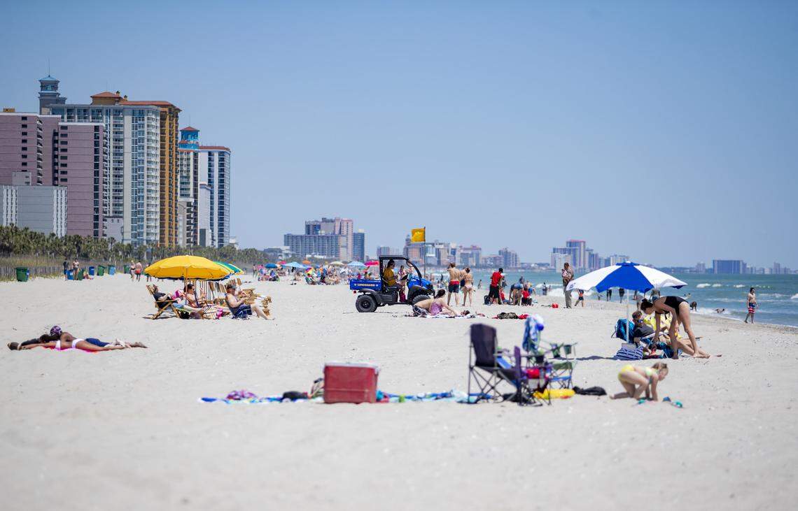 People enjoy the beach Saturday, April 2 near the Myrtle Beach boardwalk. Public beach accesses are officially open, while hotels, short-term rentals and other accommodations services in Myrtle Beach could reopen this week following a roughly three-week shutdown caused by the coronavirus.