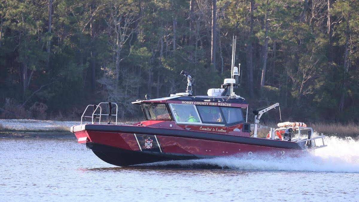 1 missing after boat takes on water in North Myrtle Beach. Crowd gathers to await news.