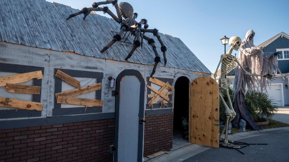 Randy Dorebos works to build a haunted house in his The Farm at Carolina Forest neighborhood on Thursday, Oct. 20, 2022. The shocking displays, which often feature neighbors in costume and make-up, have become popular draw for visitors from around the area.