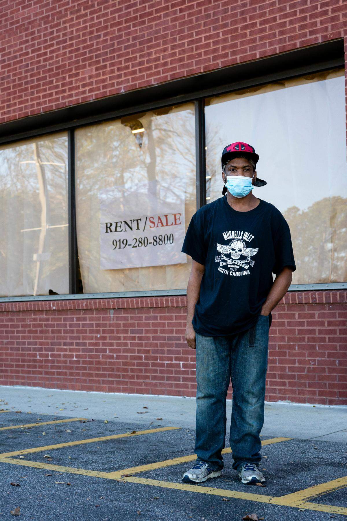 Shawn Barnes stands outside of the former Food Lion. He is waiting for the payday loan store next door to open. He lost his job when the Food Lion closed and he couldn’t transfer to another store.