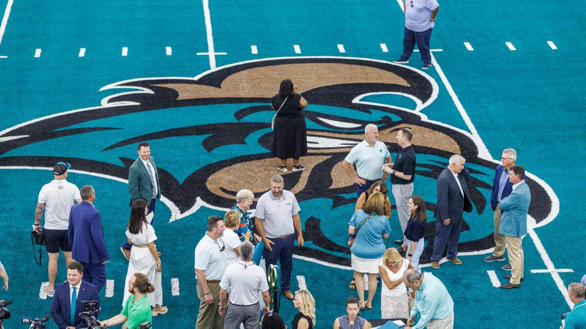 Coastal Carolina University held a ribbon cutting ceremony for their new Indoor Practice Facility on Wednesday. The 93,000 square foot practice field that was built directly across the street from Brooks Stadium came at the cost of $20 million and is considered the largest donor-funded project in school history. The giant building features a regulation-sized iconic teal turf football field, filming platforms, storage rooms, bath rooms and areas for athletic trainers. After comments from university officials and a ribbon cutting, members of CCU’s football team took to the field along with head football coach Tim Beck to marvel over the space and take selfies inside. Wednesday. June 25, 2025.