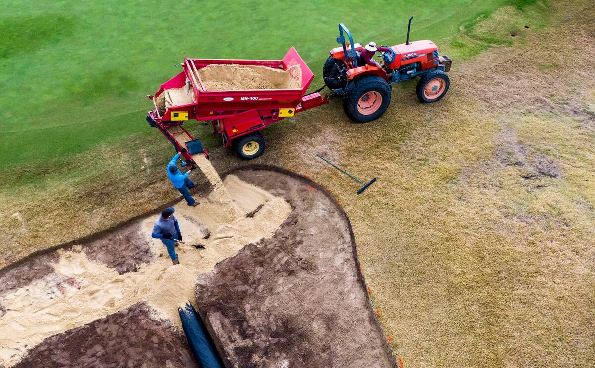 Crews work to add sand into a bunker on the ninth hole at the Members Club at Grande Dunes in Myrtle Beach on Jan. 15.
