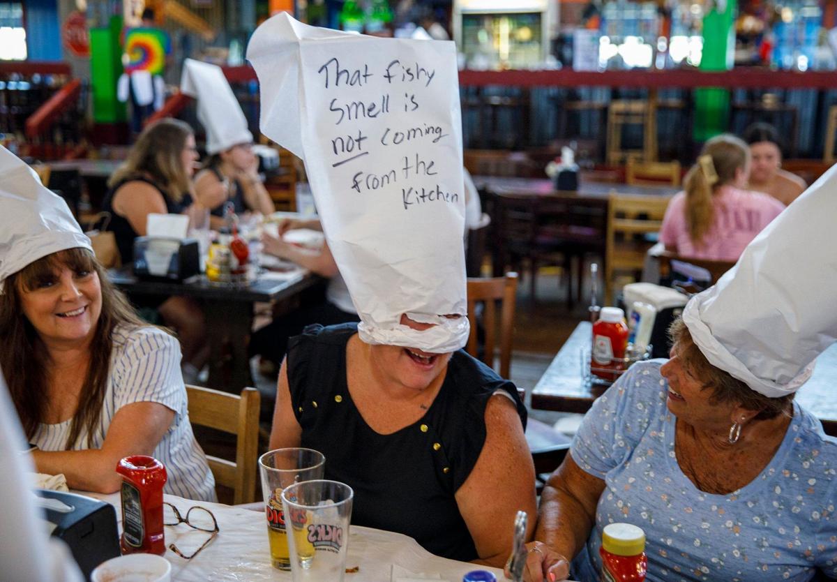 Customers wear paper hats created by their servers. An inside look at Dick’s Last Resort at Barefoot Landing in North Myrtle Beach, a theme restaurant where visitors can expect light hearted jokes from the staff. The first Dick’s Last Resort opened in Dallas in 1985. The Barefoot Landing location opened in 1992 and today the chain has 12 locations around the country. Aug. 12, 2024.