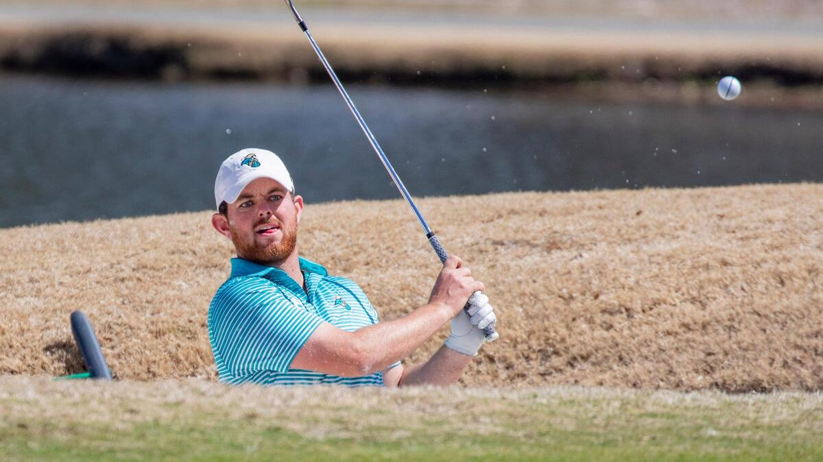 Coastal Carolina senior golfer Morgan Deneen chips out of a sand trap on the 18th green at The Dunes Golf and Club Tuesday during the General Hackler Championship in Myrtle Beach.