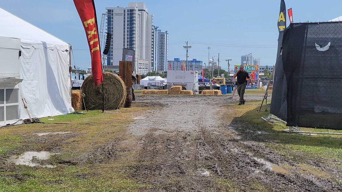 Gray sand and gravel covered mud near an exit at the Carolina Country Music Festival Thursday afternoon.