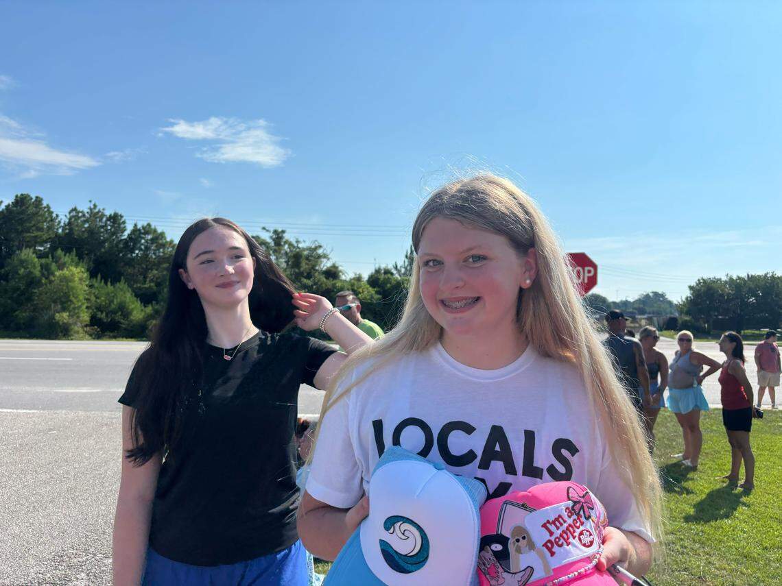 Everleigh Dogel and Sophia Deagan, both 13, wait near the set of Outer Banks in Myrtle Beach hoping some of the stars will sign their hats.