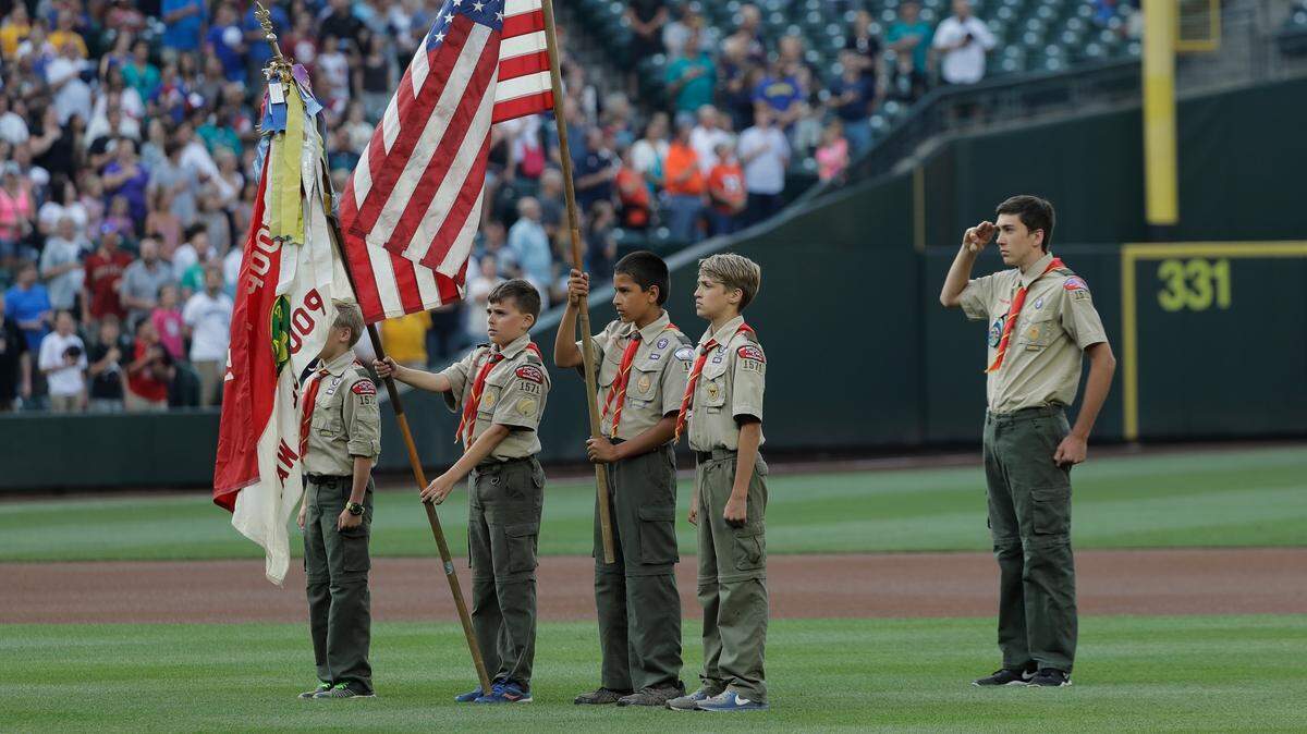 Boy Scouts from Troop 1571 in Poulsbo, Wash., present the flag during the singing of the national anthem before a baseball game between the Seattle Mariners and the Houston Astros, Monday, July 30, 2018, in Seattle.