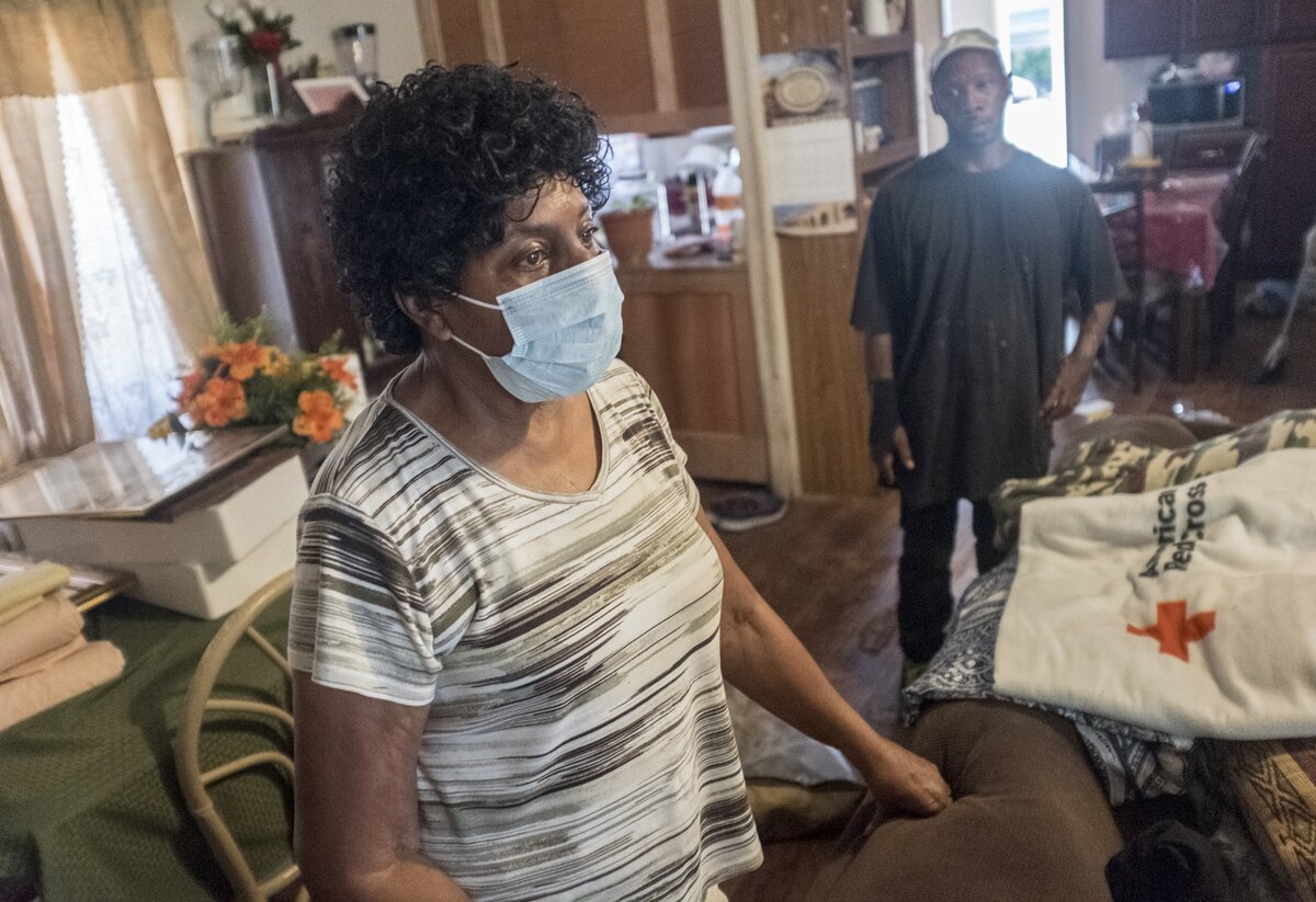 Rebecca Sherman along with her son Jerome Sherman look through the contents of their flooded home of Martin Luther Drive in Bucksport. The Red Cross blanket pictured was a hold over from the flooding of Hurricane Matthew almost two years ago. Wednesday. October 3, 2018.