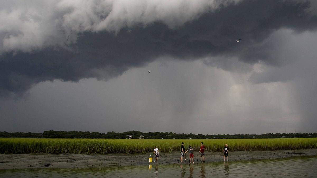 Ignoring the gathering storm, people fish and crab in the marsh surrounding the western side of Pawleys Island. 07/24/12
