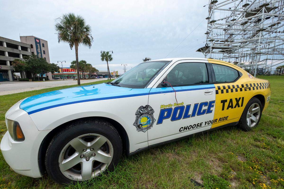 Cars placed around the area by the City of Myrtle Beach has the paint scheme of a police car in the front and a taxi in the back to discourage drinking and driving. Sept. 1, 2022.