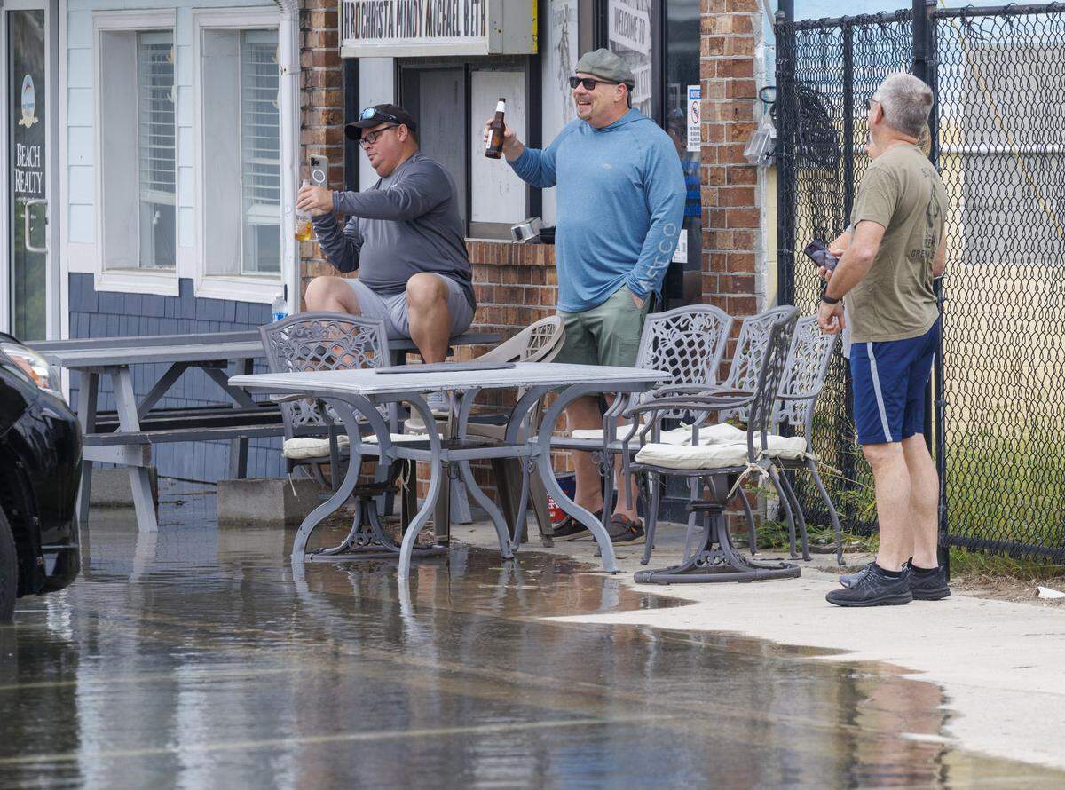 King tides flood the streets of the Garden City community South of Myrtle Beach, SC. The beach town’s low lying streets and businesses flood a few times a year due to the celestial events. Drivers are warned away from driving through flood waters as business owners work to protect their properties. Oct.11, 2025.