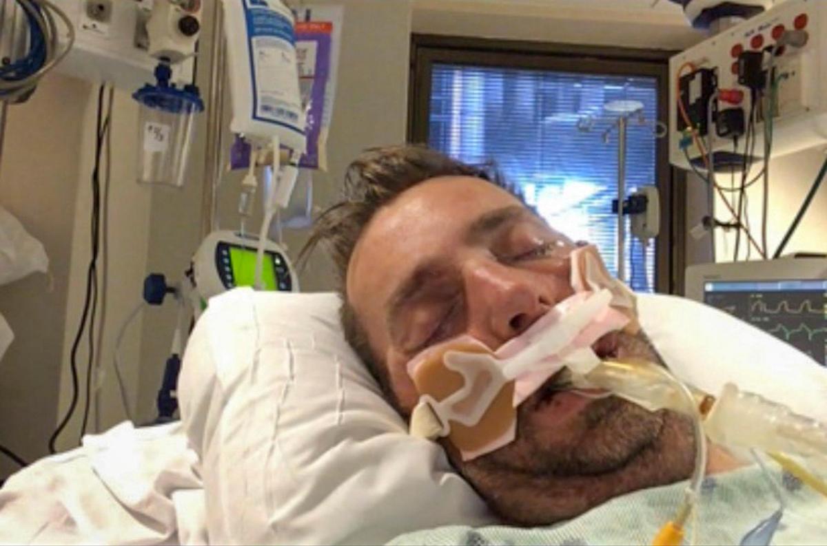 In a submitted photo, Chad Hardee lay in a hospital bed suffering from COVID Pneumonia. February 3, 2021.
