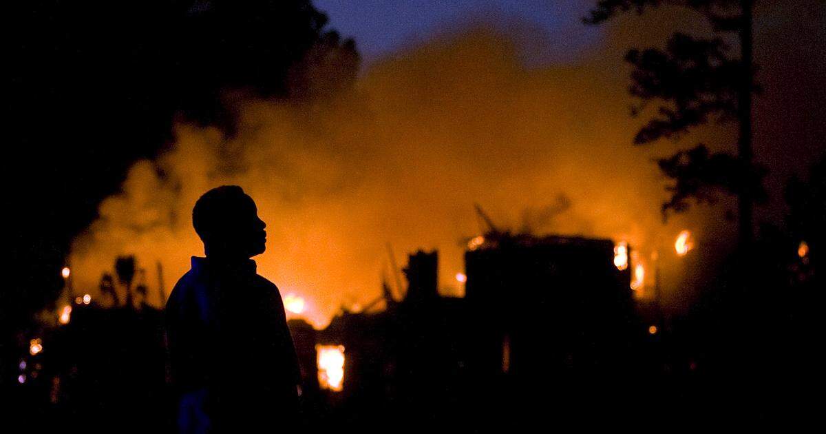 Flames and smoke fill the forest as between nine and 15 buildings are destroyed in the Windsor Green condominium community of Carolina Forest on Saturday, March 16, 2013.