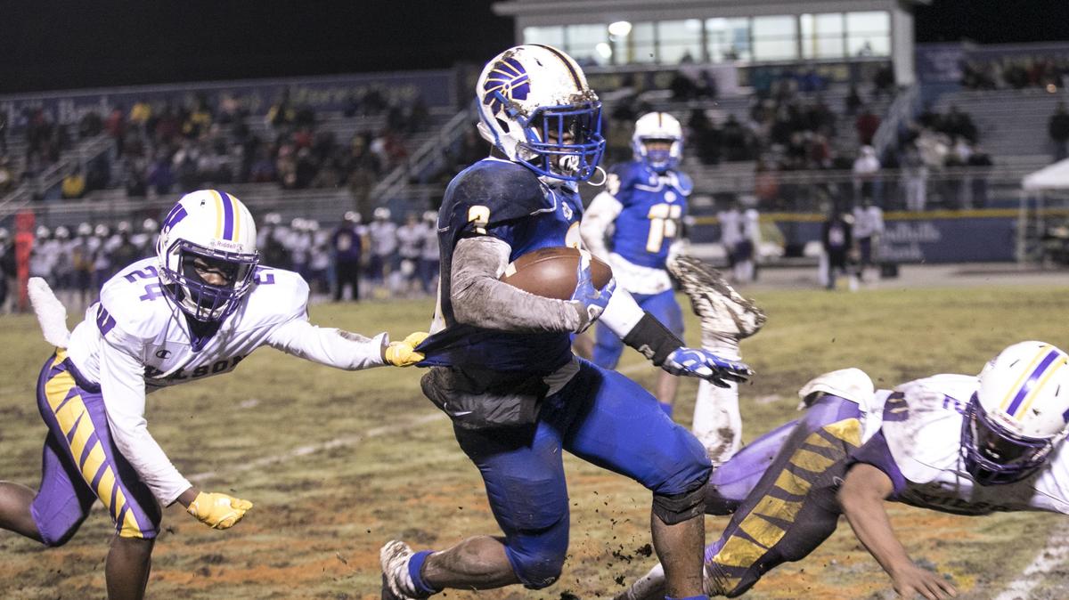 North Myrtle Beach’s Ramsey Lewis drives the ball past Wilson defenders in the mud. North Myrtle Beach got to an early lead in the second round of Class 4A playoffs Friday night. Nov 16, 2018.
