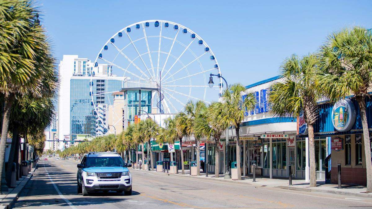 A Myrtle Beach police officer drives along Ocean Boulevard.