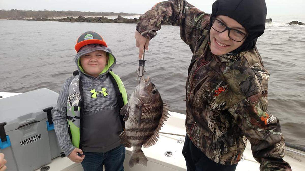 Brightin Baxley and Christopher Karavan of Conway show off a 5.5-pound sheepshead caught Saturday while fishing with Capt. Mike McDonald of Gul-R-Boy Guide Service.