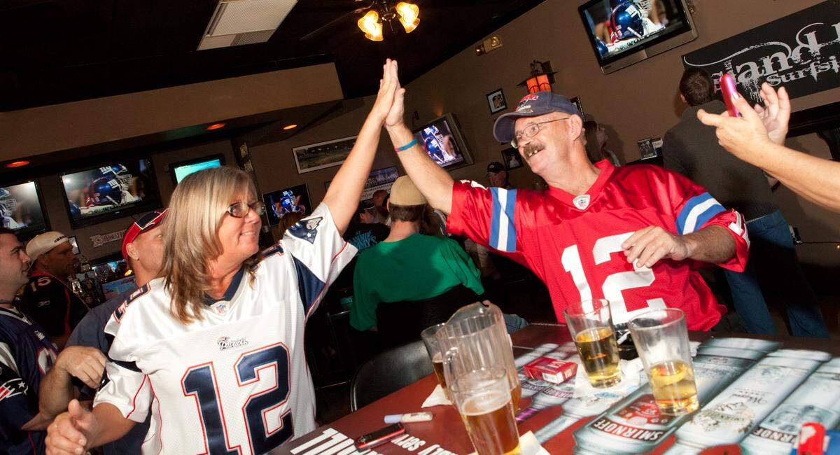 Karin Bushaw and her brother Philip Storer celebrate the first touchdown of the game as New England Patriots fans gather at Island Bar and Grill on Glenns Bay Road in Surfside Beach Sunday to watch their team square off against the New York Giants in Super Bowl XLVI in this Su News file photo.