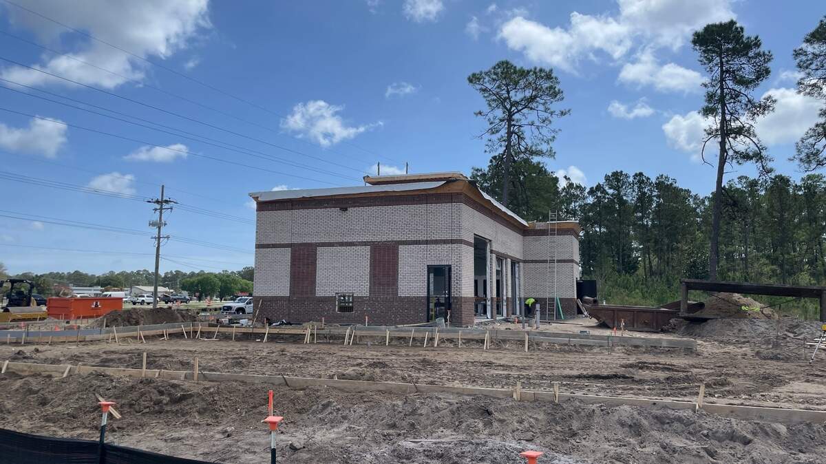 Construction crews work on a new storefront near Conway, S.C. The property will be a new Valvoline shop, the third built along the Grand Strand since 2023.
