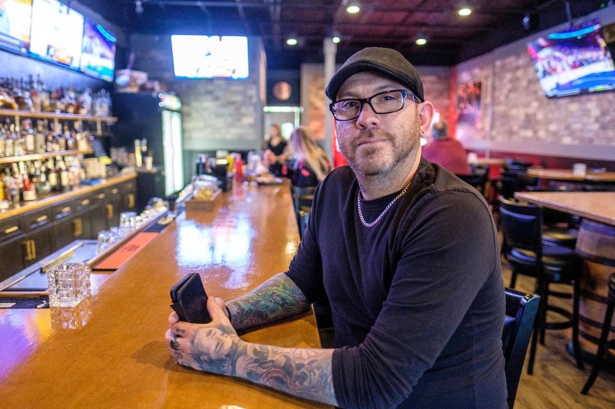 Wiseguys Bar & Grill owner and operator Phil Goldman sits at the end of the bar which features gangster-themed murals and live entertainment in Myrtle Beach, S.C. Oct. 19, 2021.
