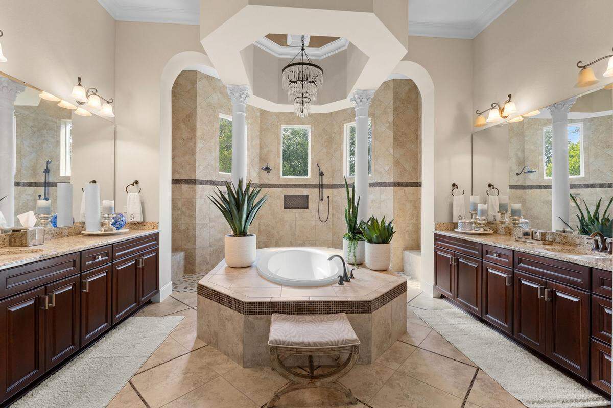 The primary suite’s bathroom has a soaking tub and walk-in shower.