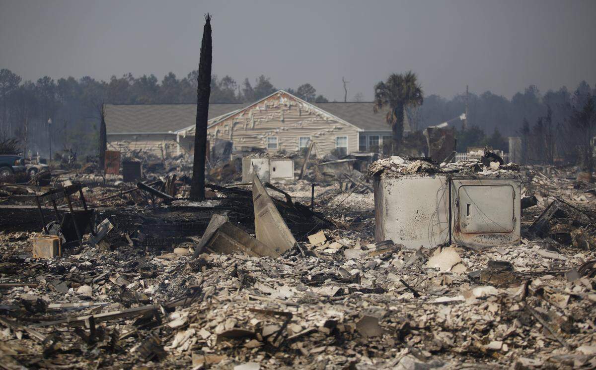 04-23-09/Thursday-----A row of houses lay damaged Thursday afternoon in the Barefoot Resort community in North Myrtle Beach. The Highway 31 fire has burned over 14,000 acres and taken over 60 homes in this community alone.____Photo By Randall Hill__rhill@thesunnews.com